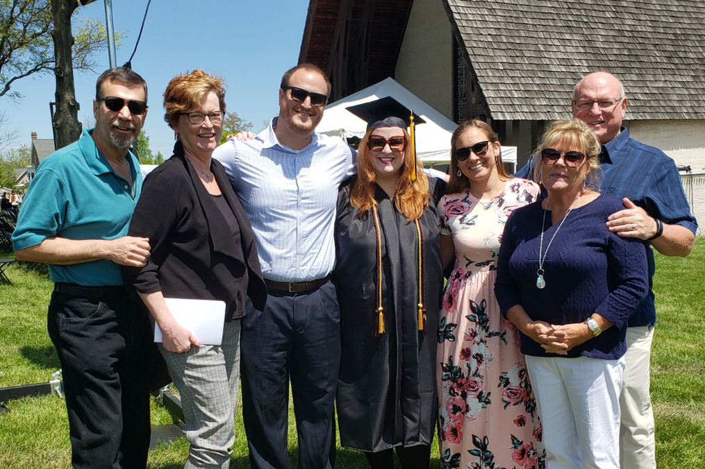 Alyssa Frederick stands with her family after graduation.