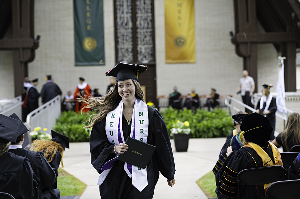Nursing student Chloe Sears walking with diploma