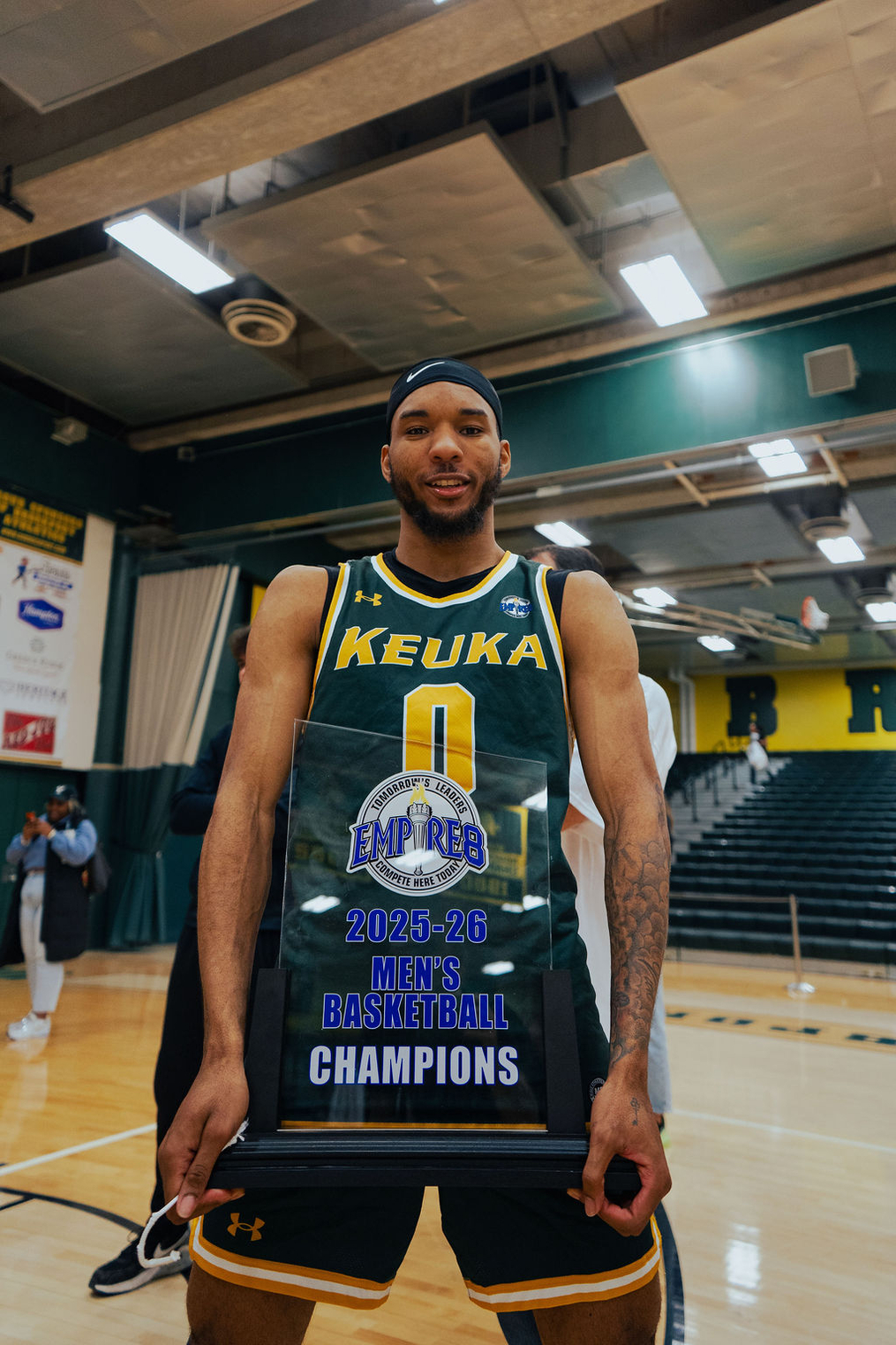 Empire 8 Tournament MVP Lamar Lovelace of Rochester shows off the trophy. 